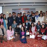 Youth participants pose with their mentors at the December 2010 launch of Through the Gender Lens, a handbook to help combat violence against women.